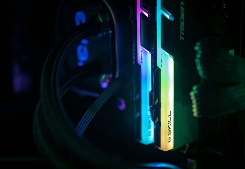 a close up of a computer and wires in a dark room
