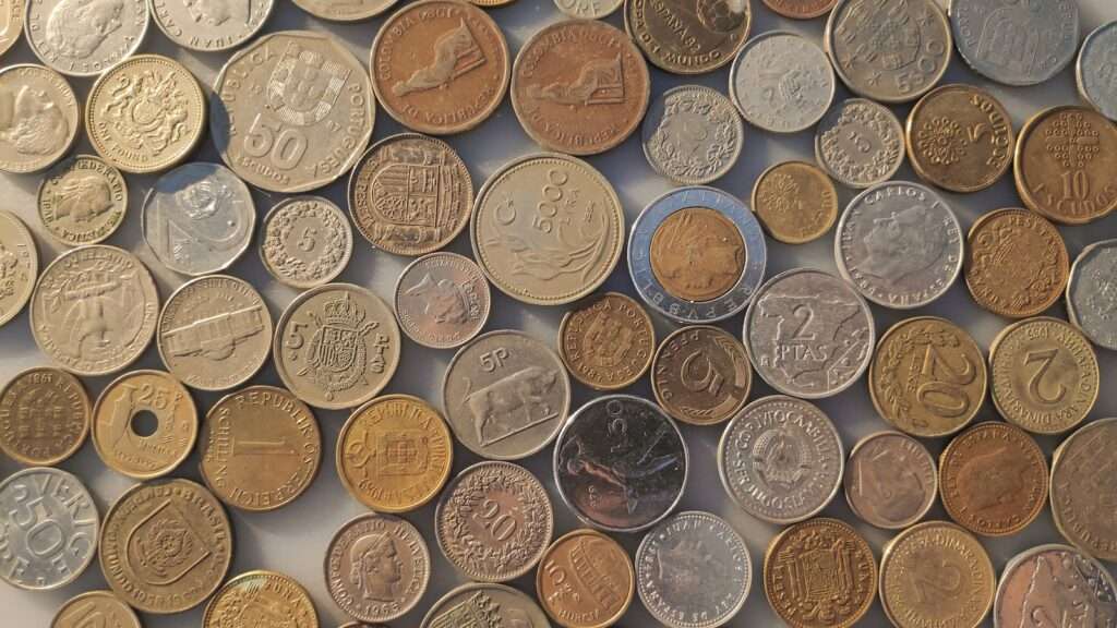 a pile of different coins sitting on top of each other